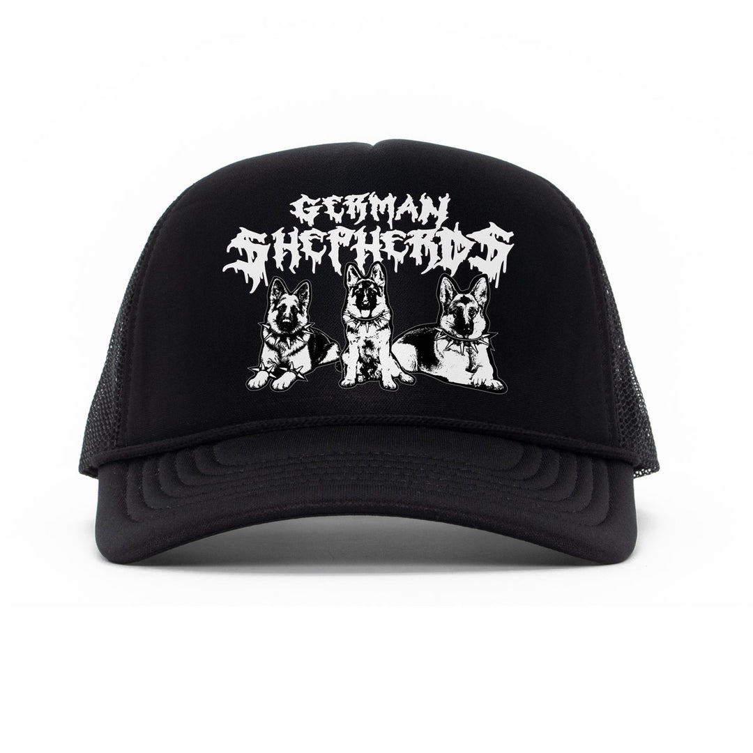 A black trucker hat with a white graphic print featuring the text 'German Shepherd' in a stylized font above three illustrations of German Shepherd dogs, shown against a plain white background.