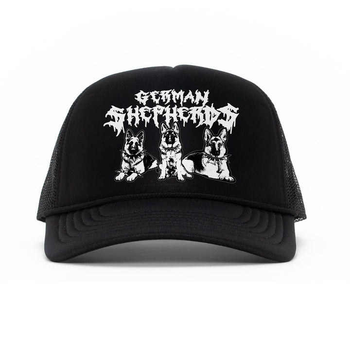 A black trucker hat with a white graphic print featuring the text 'German Shepherd' in a stylized font above three illustrations of German Shepherd dogs, shown against a plain white background.