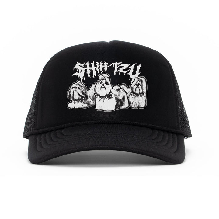 A black trucker hat with a white embroidered graphic of a muscular bearded man and the stylized text 'Shih Tzu' on the front, set against a plain white background.
