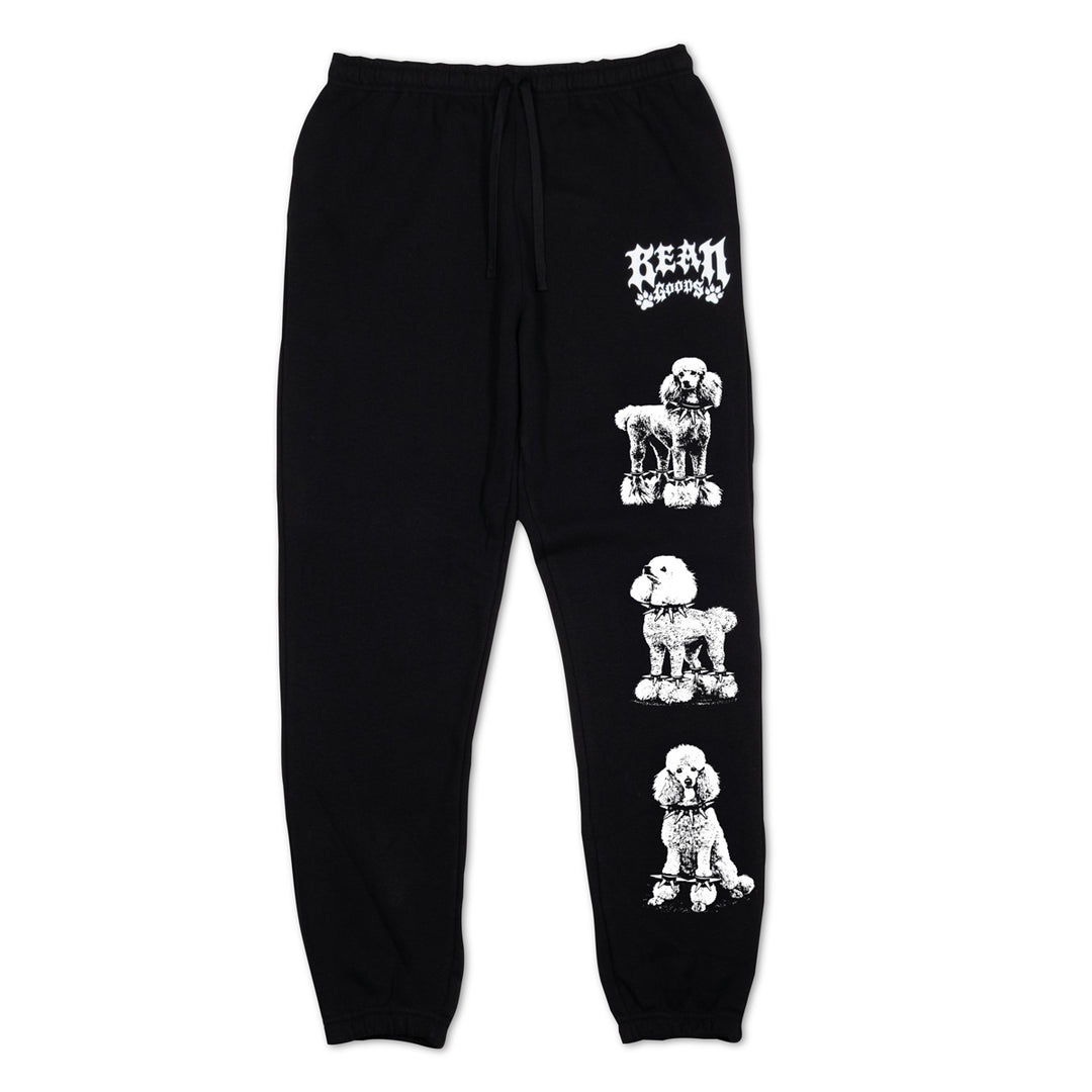 Black jogger sweatpants featuring a vertical white graphic print of three poodles and a stylized 'BEAN GOODS' logo near the upper thigh, shown against a plain white background.