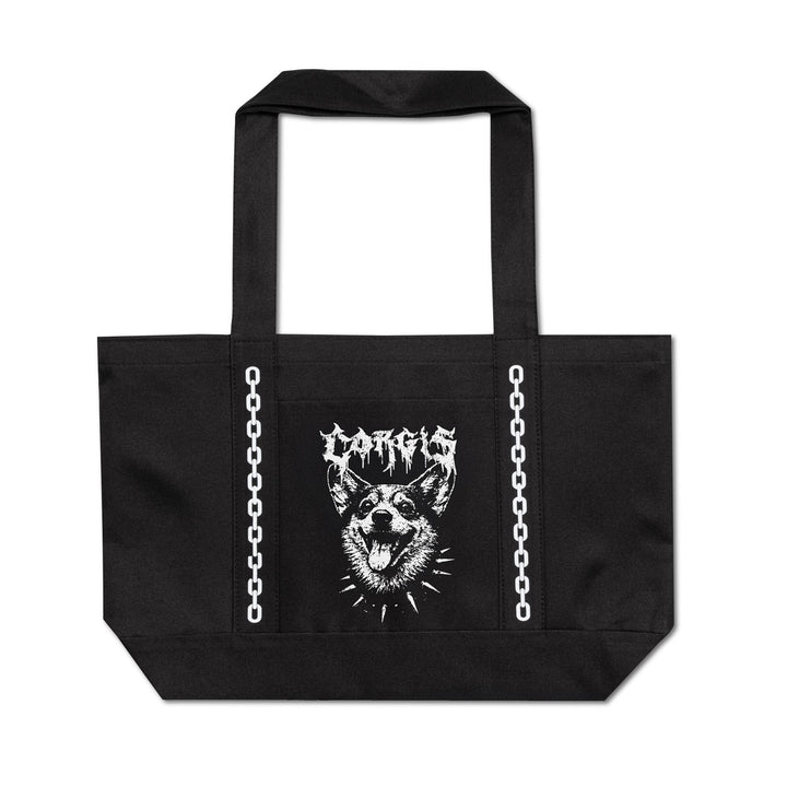 A black canvas tote bag with two top handles, featuring a white graphic print of a spiky dog head and the word 'CORGIS' in a metal-style font on the front. White chain graphics run vertically down both sides of the bag.