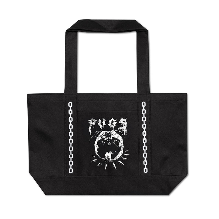 A black canvas tote bag with two shoulder straps, featuring a white graphic print on the front. The graphic includes the word 'PUGS' in a distressed, stylized font above a circular dog head illustration with a spiked collar and a sunburst.