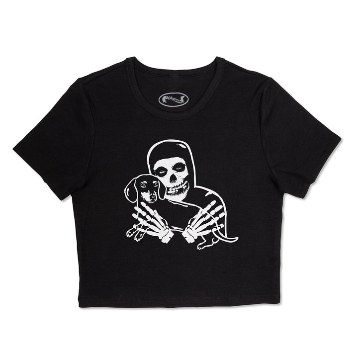 Black ribbed cropped tee featuring a white graphic of a crimson skeleton figure holding a small dachshund, shown against a plain white background.